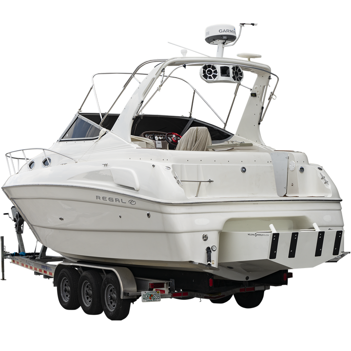 Alt text: A white Regal Commodore 28 boat mounted on a trailer, featuring a custom high flotation twin outboard engine bracket at the stern. The boat has tinted windows, a radar arch, and various electronic equipment on top. The background is transparent with a checkered pattern