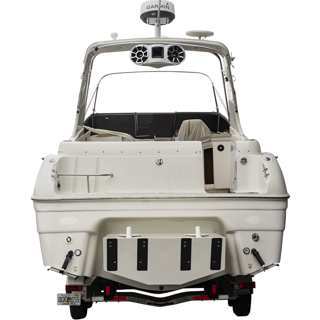 A white Regal Commodore 28 boat mounted on a trailer, featuring a custom high flotation twin outboard engine bracket at the stern. The boat has tinted windows, a radar arch, and various electronic equipment on top. The background is transparent with a checkered pattern