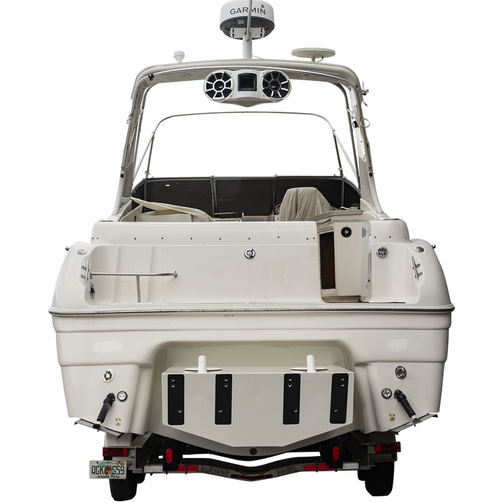 A white Regal Commodore 28 boat mounted on a trailer, featuring a custom high flotation twin outboard engine bracket at the stern. The boat has tinted windows, a radar arch, and various electronic equipment on top. The background is transparent with a checkered pattern