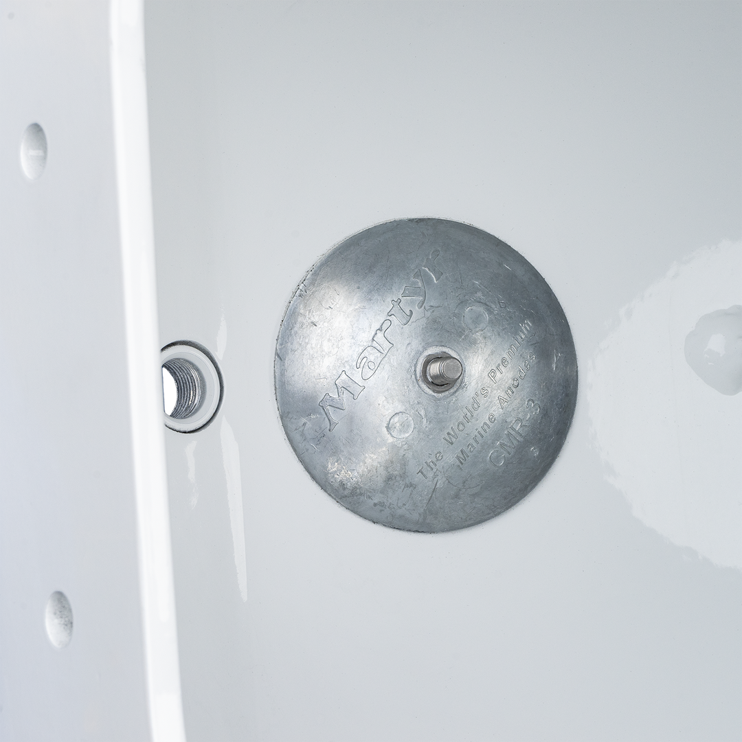 Alt text: A metallic Apex Mk. 2 NSP Single Engine Bracket with a circular shape, featuring engraved text and a central hole. Next to it is a smaller threaded component, both placed against a plain white background