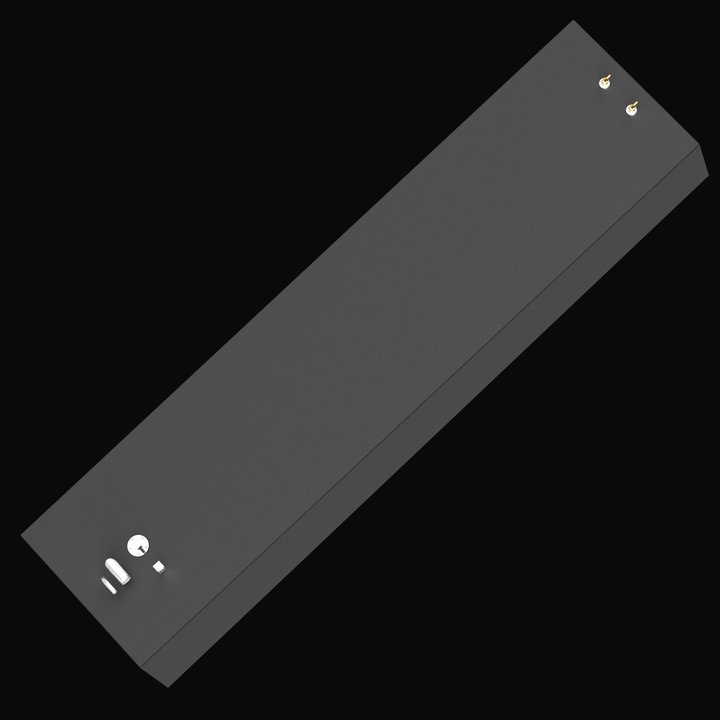 A 3D rendered model of a long, rectangular black marine fuel tank with beveled front corners, viewed from a high angle above the rear-right side. The tank features several fittings on its top surface, including two small brass fittings near the rear-right corner and multiple silver pipe components and caps near the front-left corner. The tank has a smooth matte black finish and is displayed on a plain black background