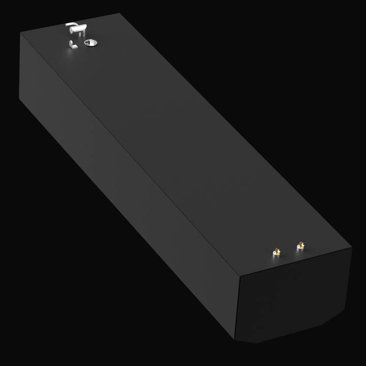 3D rendered image of a long rectangular black marine fuel tank with beveled front corners, shown from a rear-right perspective. The tank has a matte black finish, with two small brass fittings on the rear-right side and a cluster of white fittings including a cap on the front-left top surface. The background is solid black.
