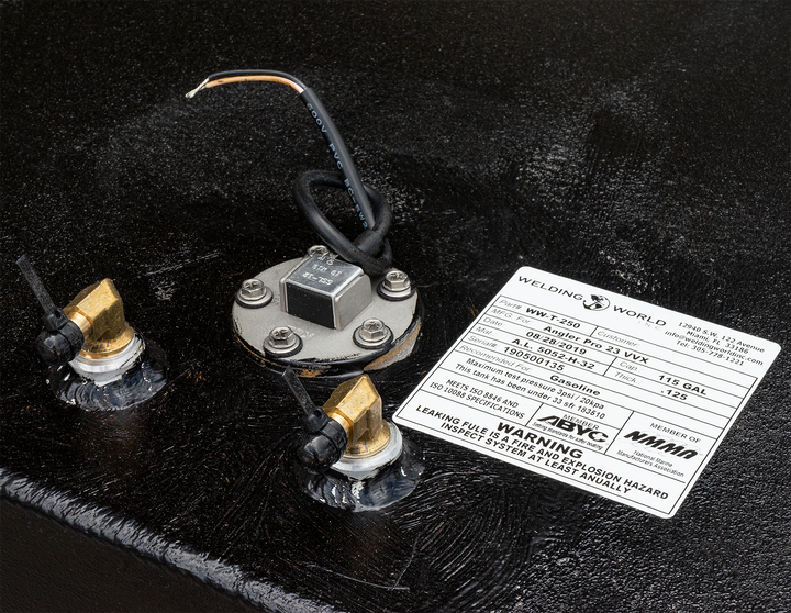 Close-up view of the Angler 230 VBX OEM replacement belly fuel tank, featuring a fuel gauge, electrical wiring, and two brass fittings on a textured black surface, with a warning label attached