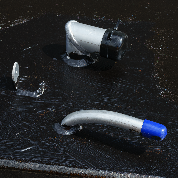 Close-up view of a Contender 31' OEM Replacement Fuel Tank Combo Kit, featuring a small belly tank with a capacity of 75 gallons and two standard saddle tanks. The image shows a fuel fitting and a hose connection on the tank's surface