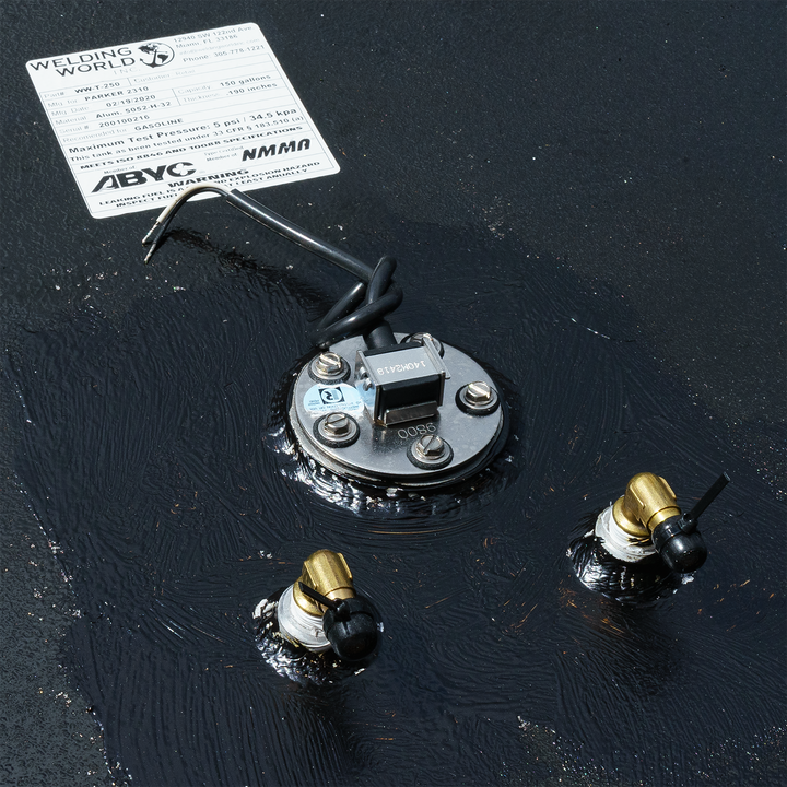 Close-up view of the Contender 31' OEM Replacement Fuel Tank Combo Kit #2, featuring a small belly tank (75 gallons) and two standard saddle tanks. The image shows the fuel tank's top with a fuel sender unit and two fuel fittings, surrounded by a black sealant