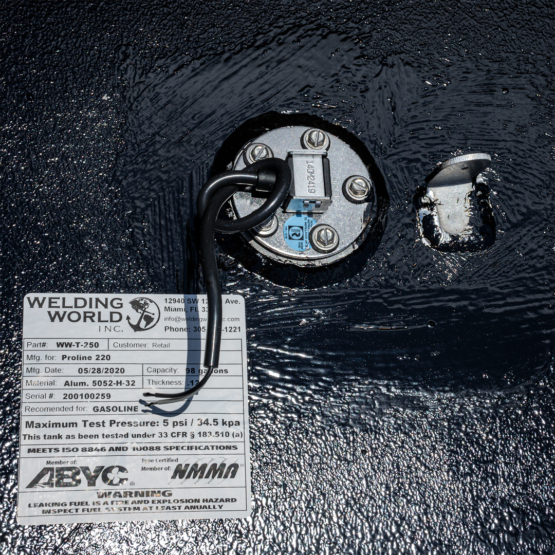Close-up of a 1998 Proline 220 OEM replacement fuel tank featuring a fuel sender unit and a label from Welding World, indicating specifications and safety warnings. The tank has a capacity of 98 gallons and is designed for gasoline use