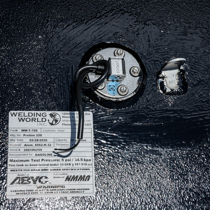 Close-up of a 1998 Proline 220 OEM replacement fuel tank featuring a fuel sender unit and a label from Welding World, indicating specifications and safety warnings. The tank has a capacity of 98 gallons and is designed for gasoline use