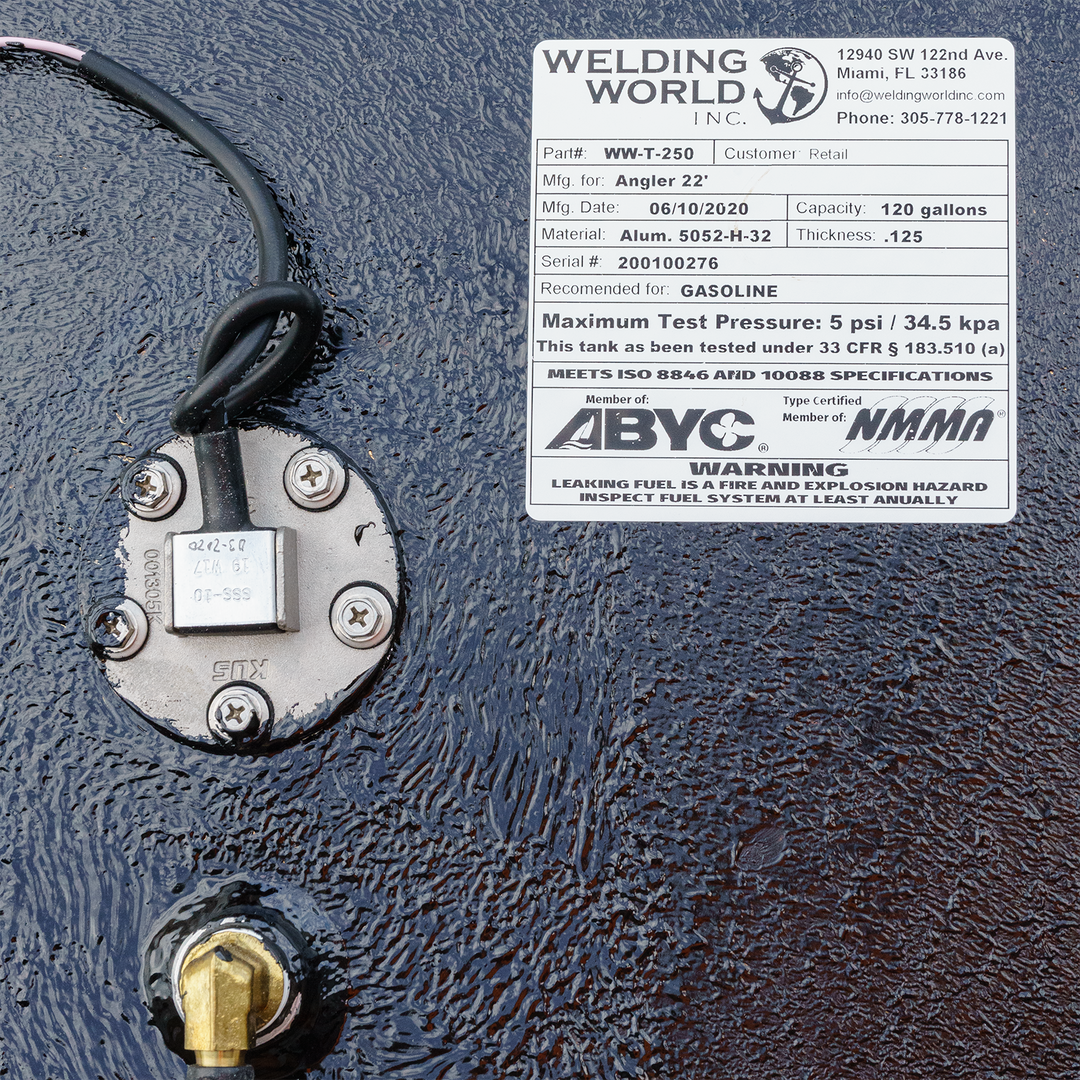 Close-up of a 22-foot Angler boat's OEM replacement belly fuel tank, featuring a 120-gallon capacity, with a fuel gauge and warning label indicating gasoline use. The tank is mounted on a textured surface, showing wiring and a fuel fitting