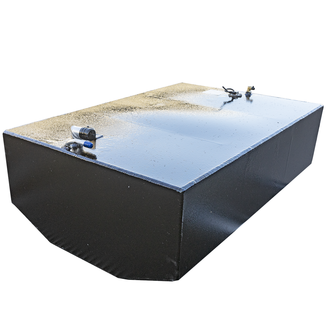 A black, rectangular fuel tank with a textured surface and chamfered bottom edges is angled against a black and grey checkerboard background. Its top surface features various fittings, including a white and blue hose connection, and a brass-colored valve. The image highlights the tank's construction and surface details