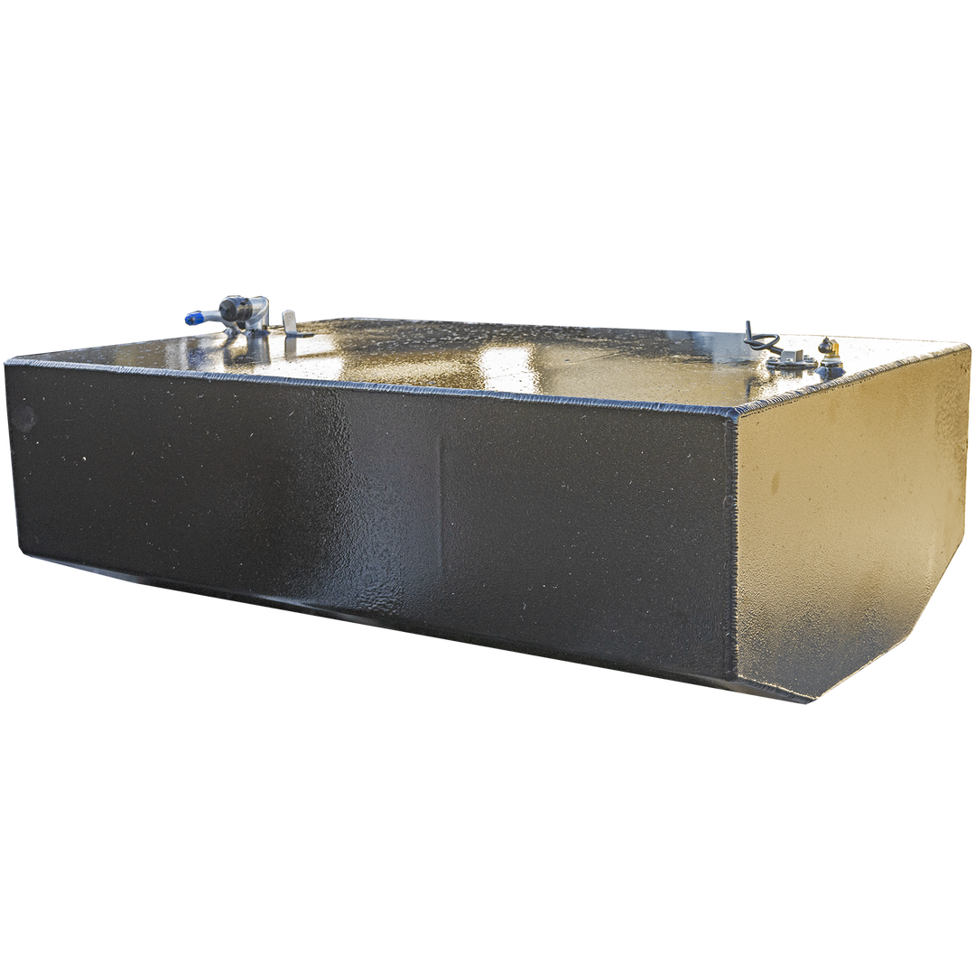 A black, rectangular fuel tank with a textured surface is angled against a checkerboard background. Its top surface features a white and blue hose connection on the left, and a brass-colored valve and a small white label on the right. The tank has chamfered bottom edges, and the lighting highlights the texture and metallic elements
