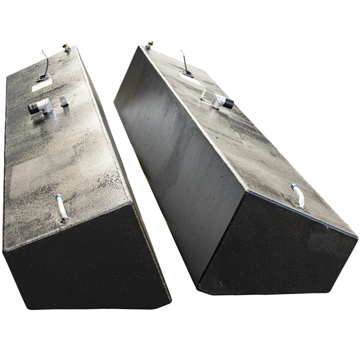 A pair of tall, narrow, black-coated boat fuel tanks, presented as a port and starboard set. The tanks are standing upright and angled away from each other against a checkered background, emphasizing their height. They are mirror images, each with a textured finish and an identical arrangement of fuel fittings, valves, and a sending unit on their flat top surfacces