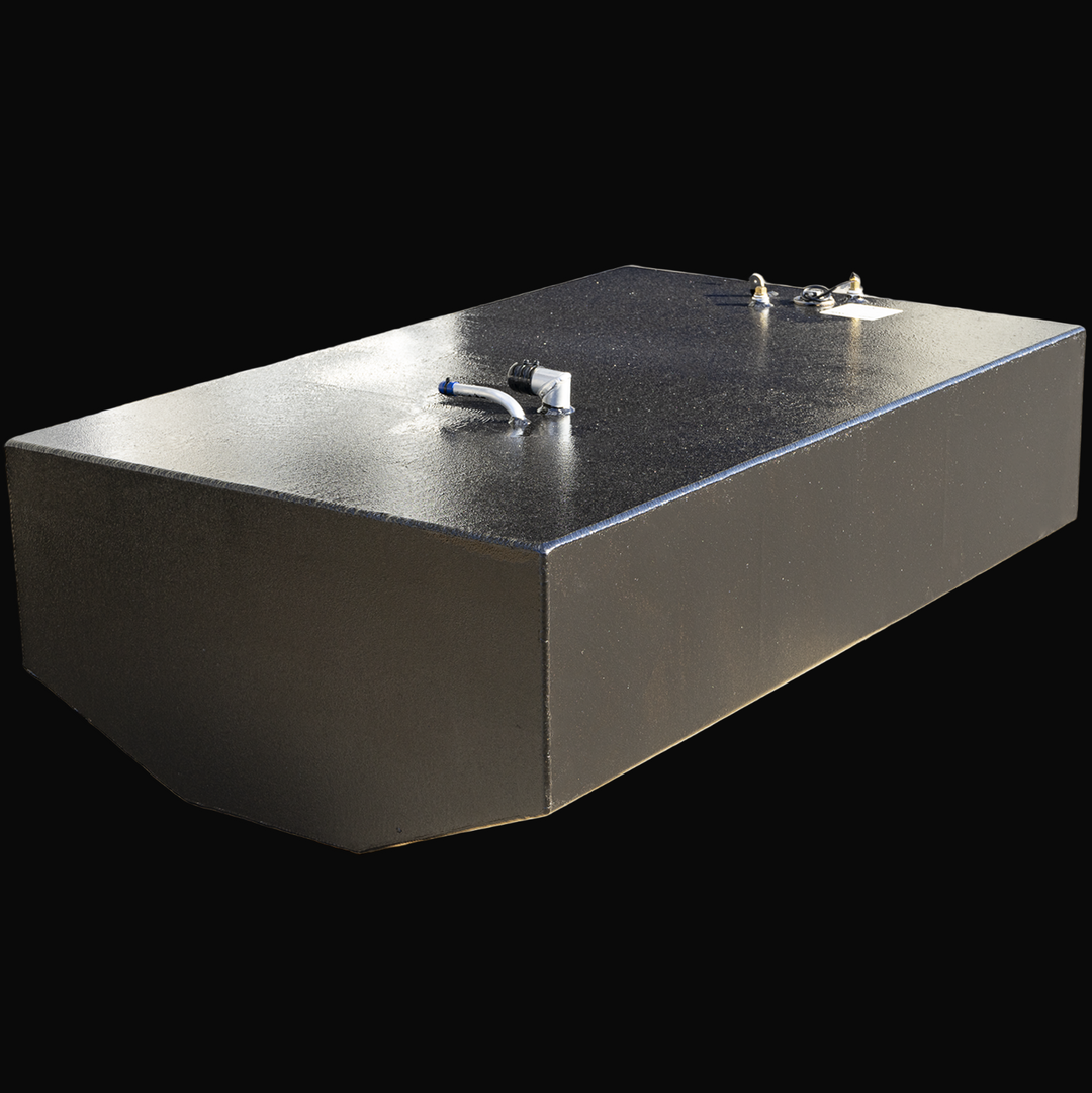 A large black rectangular boat fuel tank with slightly angled edges on the front. The top surface has several fittings including a white and blue angled pipe, a small brass valve, and other connectors near a label. The tank has a rough textured finish and is displayed against a transparent background