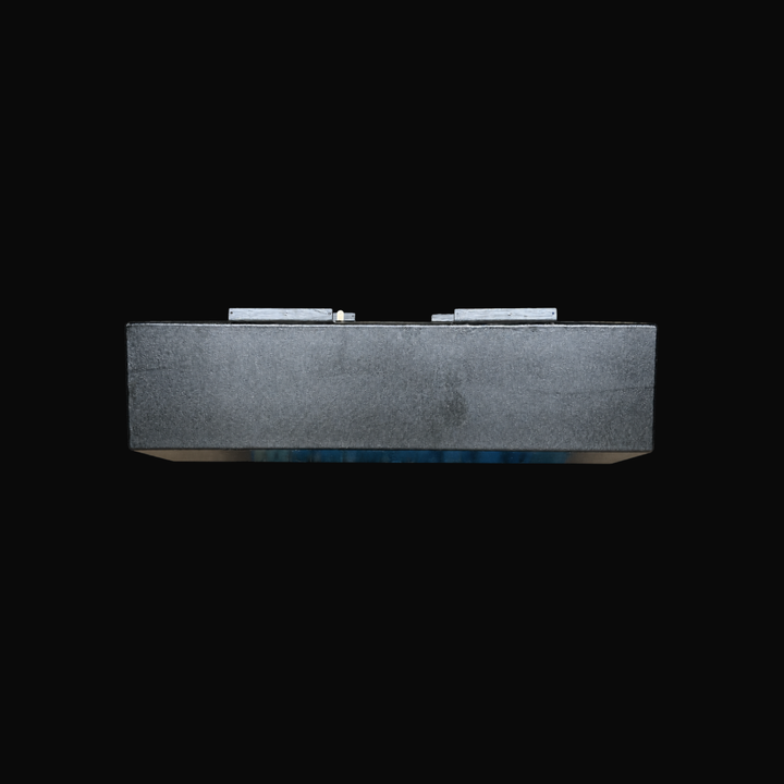 A straight-on side elevation studio view of a physical, finished black encapsulated 2003 Boston Whaler Outrage 240 OEM replacement marine fuel tank from file image_e68644.jpg, isolated against a black background. This side-profile perspective emphasizes the long rectangular profile and the thick, protective, textured black TarGard epoxy coating applied over the heavy-gauge marine-grade 5052-H32 aluminum tank shell to provide maximum resistance against saltwater pitting and bilge cavity moisture. Along the t