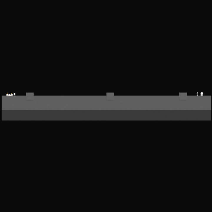 A side profile rendering of a long, rectangular marine fuel tank. The view focuses on the top surface layout, showing a cluster of brass and silver fittings (likely for fuel pickup and the sending unit) on the far left, and a fill or vent fitting on the far right. Three rectangular mounting tabs are spaced evenly along the length of the tank's top edge.