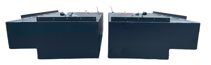 Straight side-on profile of the two black rectangular Stama 2001 marine fuel tanks, highlighting their long length, dark texture, and metal mounting rails along the upper edge.