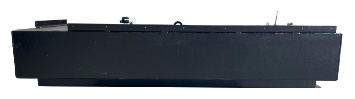 Side view of a black marine fuel tank with a textured coating, showing the lower rectangular cutout for hull clearance, and various fittings on the top surface.