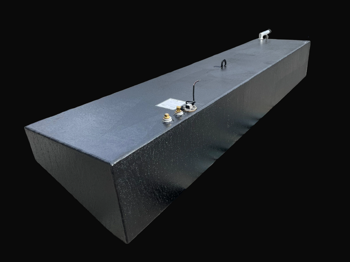 A detailed product photograph of a single, long-profile rectangular marine fuel tank with a textured black finish. The tank is shown from a high-angle perspective, highlighting its top surface which features several brass fittings, a black electrical wire, and a silver lifting eye. The far end of the tank shows the installation of a silver-toned fill neck and a smaller vent fitting.