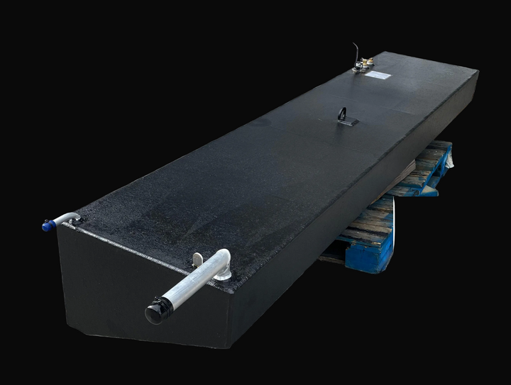 A high-angle product photograph of a long, black rectangular marine fuel tank, showcasing its textured surface and integrated hardware. Visible components include two brass fittings and an electrical wire located near the front, a single silver lifting eye in the center, and a silver fill neck with a vent tube at the far end.