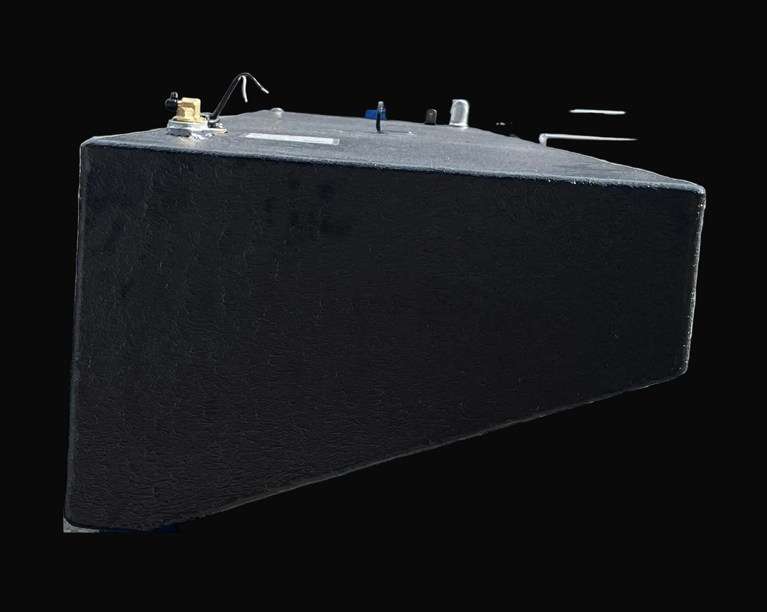 A side-angle photograph of the center fuel tank focusing on its textured black finish and its angled side wall. The image captures the top-mounted hardware, including a brass fitting and electrical lead, while demonstrating the tapering depth of the tank's hull-fitting design.
