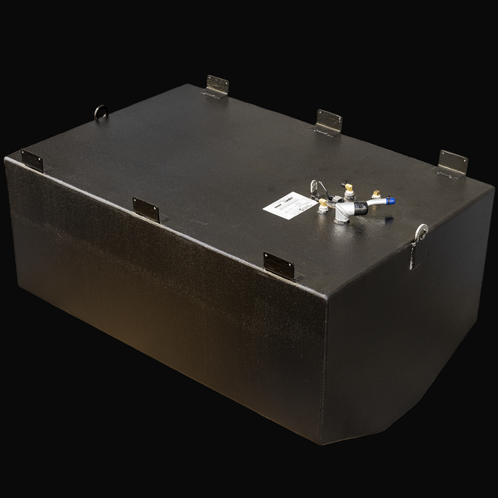 A black rectangular fuel tank viewed from an angled top front perspective. The tank has a flat top surface with multiple welded mounting tabs around the edges and two circular lifting rings on each side near the top corners. Several fittings and connectors are attached near one end of the top surface, including a white and black pipe connector with a blue tip, brass fittings, a sensor or wiring connector, and a small white cap. The tank’s sides are smooth with visible weld seams along the edges