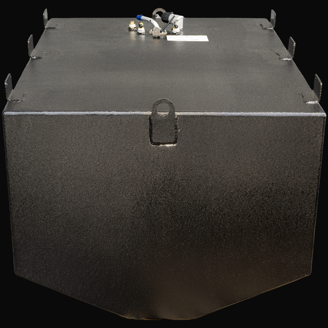 A black rectangular marine fuel tank viewed from the front angle with the narrow front face facing forward. The tank has a flat top surface with multiple welded mounting tabs along the edges. A single circular lifting ring is visible centered on the front narrow face. On the top surface, near the back, several fuel fittings and connectors are mounted, including a white plastic pipe with a blue tip, brass fittings, and a sensor with black wiring