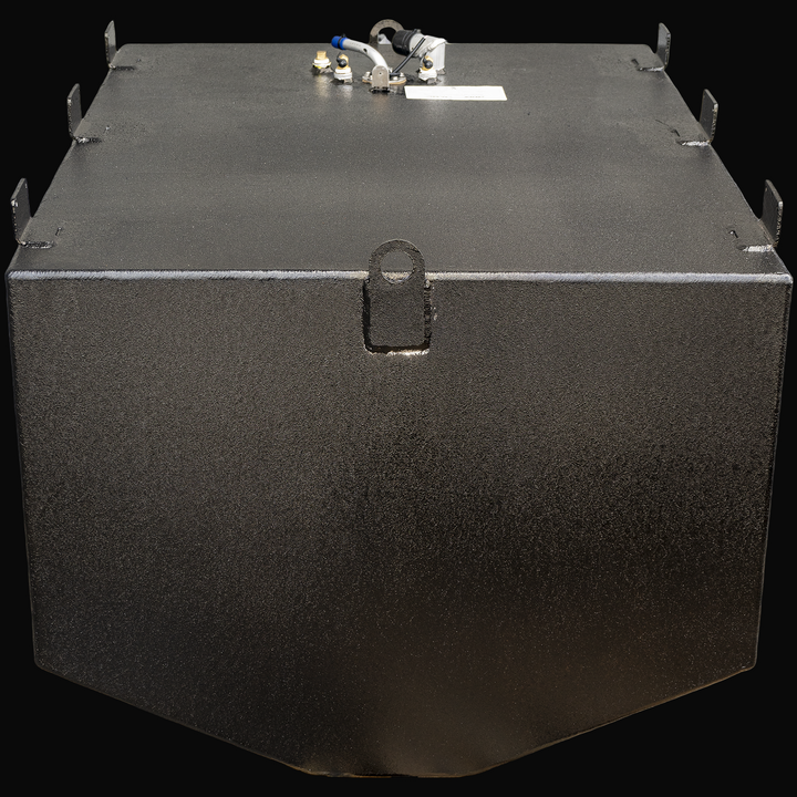 A black rectangular marine fuel tank viewed from the front angle with the narrow front face facing forward. The tank has a flat top surface with multiple welded mounting tabs along the edges. A single circular lifting ring is visible centered on the front narrow face. On the top surface, near the back, several fuel fittings and connectors are mounted, including a white plastic pipe with a blue tip, brass fittings, and a sensor with black wiring