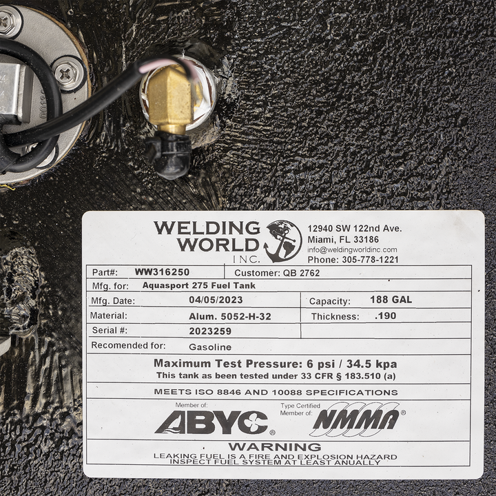 Label on a black metal fuel tank with Welding World Inc. logo and contact information. Part number WW316250, customer QB 2762. Manufactured for Aquasport 275 Fuel Tank, manufactured on 04/05/2023. Capacity 188 gallons, thickness 0.190 inches. Made from aluminum 5052-H-32. Serial number 2023259. Recommended for gasoline. Maximum test pressure 6 psi / 34.5 kpa, tested under 33 CFR § 183.510 (a). Meets ISO 8846 and 10088 specifications. Certification logos for ABYC and NMMA