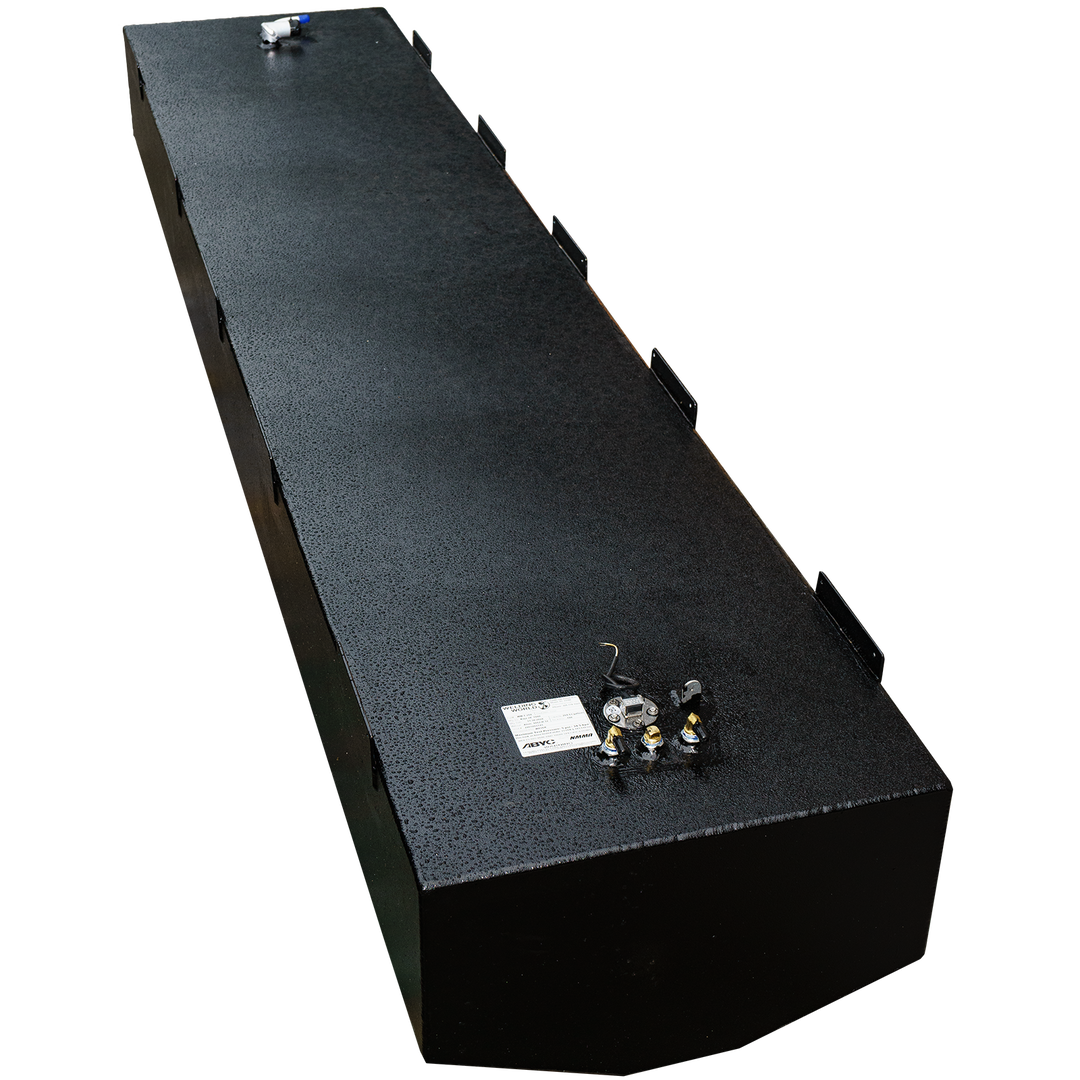 A long, rectangular, black fuel tank with a textured surface, shown from an elevated, angled perspective. It features various fittings and connections on its top surface, along with multiple mounting brackets along its sides. The foreground corner of the tank is rounded. The background is a repeating pattern of black and transparent squares