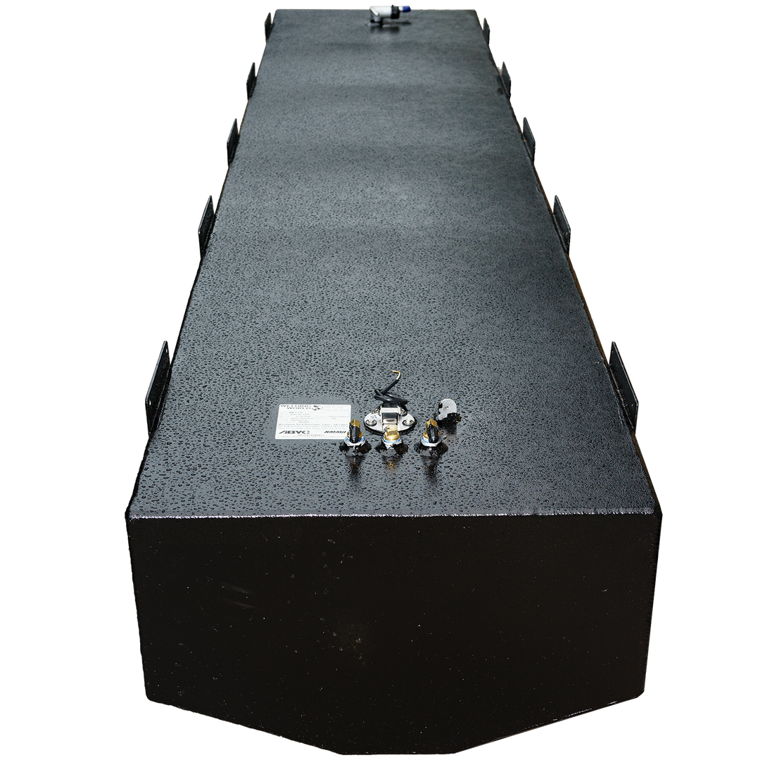 A long, black, rectangular fuel tank with a textured surface is shown from an elevated perspective. The tank, which is a Baja 280 1990 - 204 gal. OEM replacement belly fuel tank (short version), has various metal fittings and connections on its top surface, including a white label with text and small tubes. Mounting brackets are visible along the sides of the tank. The front end of the tank is subtly rounded. The background is a checkered pattern of black and transparent squares