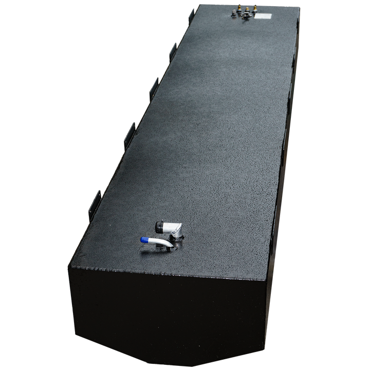 A long, black, rectangular fuel tank with a textured surface, shown from an elevated, angled perspective. It features various metal fittings and connections on its top surface, including a blue-capped tube and a set of brass-colored fittings on the far end. Multiple mounting brackets are visible along the sides of the tank. The front end of the tank is subtly rounded. The background is a checkered pattern of black and transparent squares.