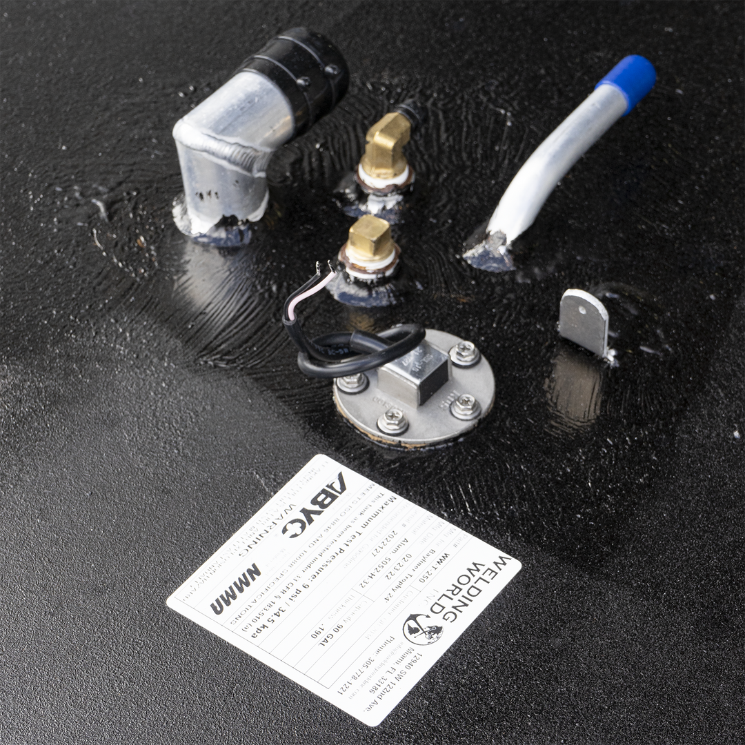 Topside hardware layout of fluid system valve block featuring mixed-metal fittings: dual brass connectors, angled black/silver elbow pipe, capped sensor unit, and electronic interface plate. Label confirms manufacturing and safety parameters—0.5 MPa pressure, 50°C temperature limit, and ½″ line compatibility. Assembly integrates manual and digital components for monitoring, control, and traceability within regulated fluid systems