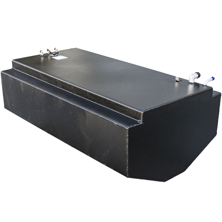 A long, black, rectangular fuel tank with a textured surface, featuring a stepped design with a raised section running along the top. The top surface shows various metal fittings, including a white L-shaped pipe with a blue tip, another white pipe, and several brass-colored connectors. The tank has a rounded front end
