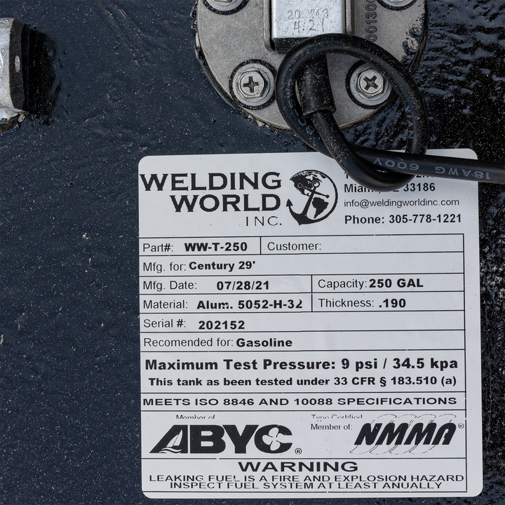 A product label for a Welding World Inc. WW-T-250 fuel tank, manufactured on July 28, 2021, for a Century 29' boat. The label specifies a 250-gallon capacity, construction from 0.190-inch thick Aluminum 5052-H-32, serial number 20152, and is recommended for gasoline. It notes a maximum test pressure of 9 psi / 34.5 kpa, compliance with 33 CFR § 183.510 (a), ISO 8846 and 10088 specifications, and memberships with ABYC and NMMA. A warning about fire and explosion hazard due to leaking fuel and annual 