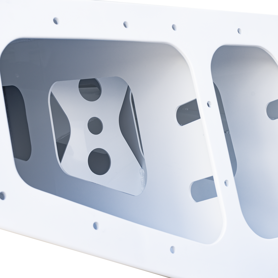 Alt text: Overexposed image of a white Chaparral 327 SSX Custom High Flotation Twin Outboard Engine Bracket, showing a rectangular frame with multiple cutouts and mounting holes. The background is black with a checkered pattern