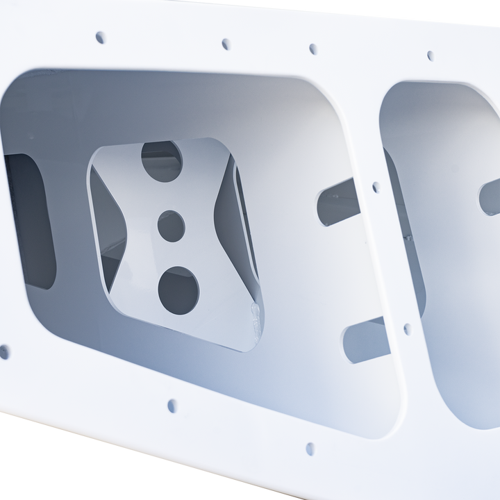 Alt text: Overexposed image of a white Chaparral 327 SSX Custom High Flotation Twin Outboard Engine Bracket, showing a rectangular frame with multiple cutouts and mounting holes. The background is black with a checkered pattern