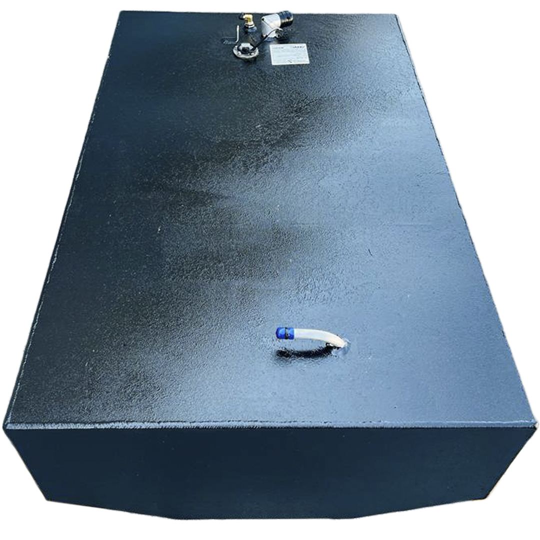 A dark, rectangular fuel tank with a textured surface is positioned against a black and grey checkered background. Various fittings are visible on its top surface, including a white, curved pipe with a blue tip on one end, and a cluster of nozzles and a white label on the other