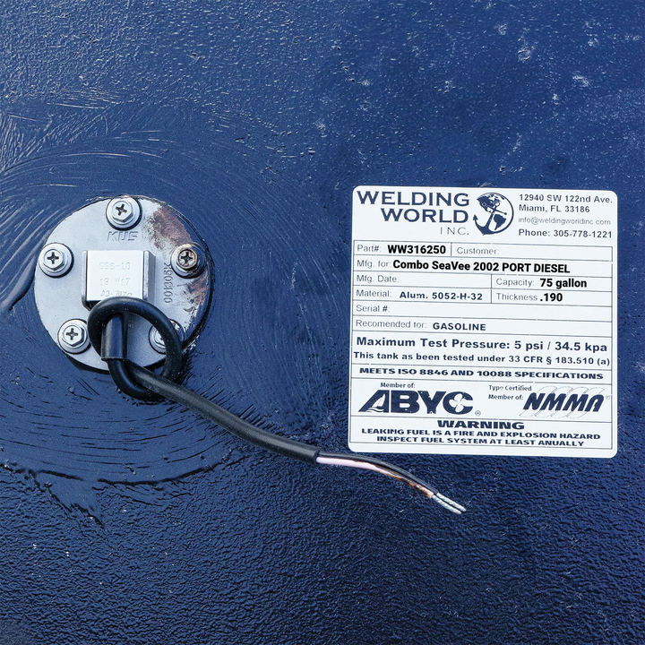 A close-up of a fuel sending unit and the white specification label on a dark textured boat fuel tank. The Welding World Inc. label lists the part as WW316250, manufactured for a "Combo SeaVee 2002 PORT DIESEL", with a 75-gallon capacity.f