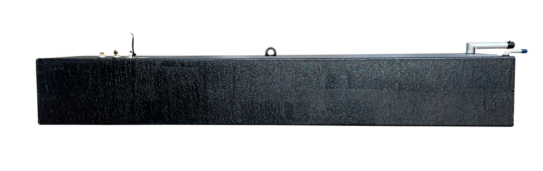 A side elevation photograph of an elongated black marine fuel tank showing its uniform rectangular height and textured surface. The top surface is visible, displaying two brass fittings at the left end, a central lifting eye, and a silver fill neck assembly at the far right end.