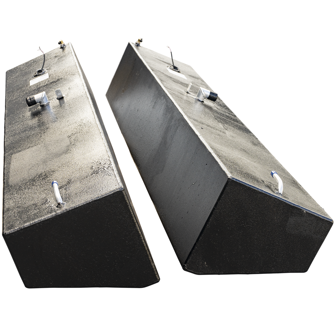 A pair of tall, narrow, black-coated boat fuel tanks, presented as a port and starboard set. The tanks are standing upright and angled away from each other against a checkered background, emphasizing their height. They are mirror images, each with a textured finish and an identical arrangement of fuel fittings, valves, and a sending unit on their flat top surfacces