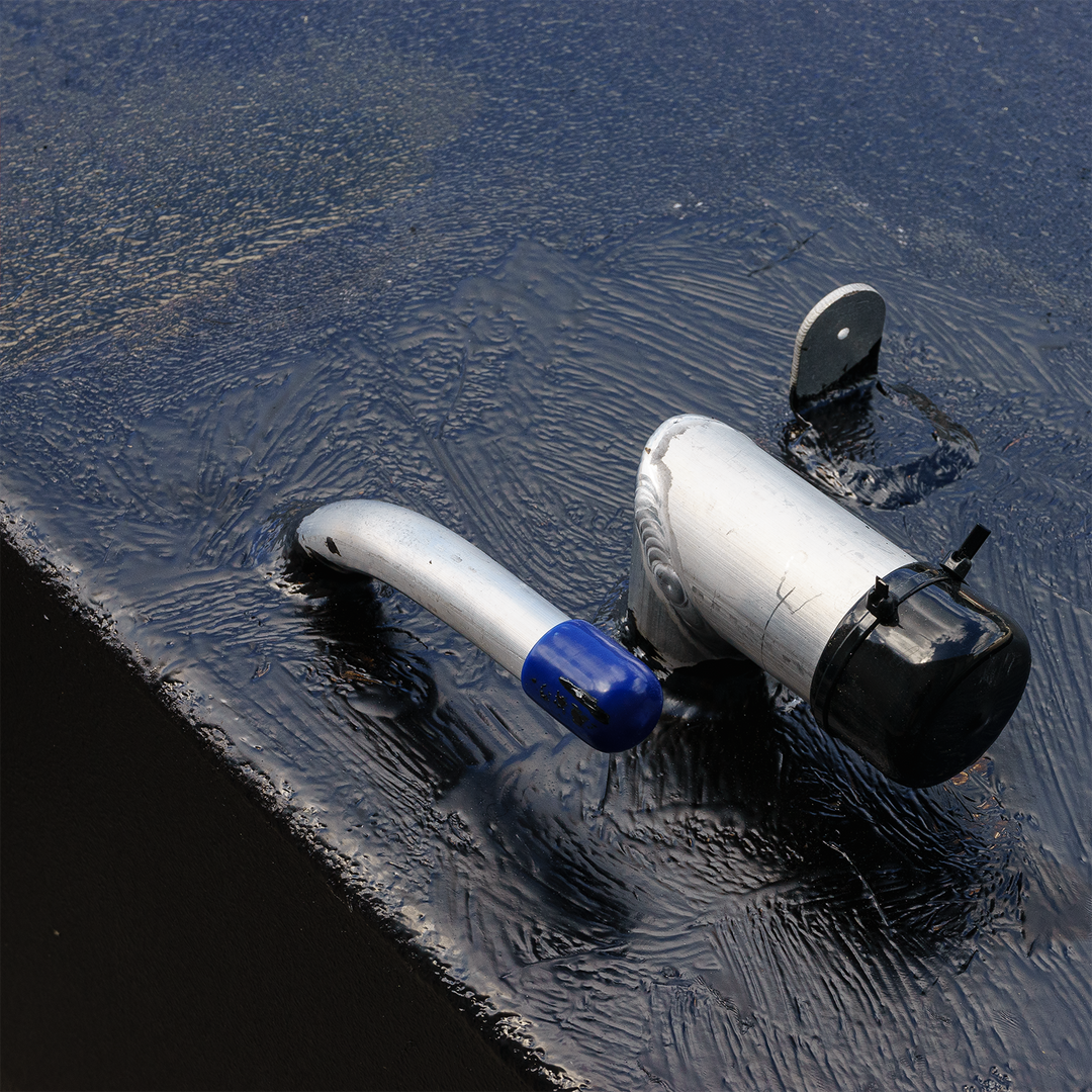 Close-up view of a fuel tank combo kit featuring a large belly tank with a capacity of 128 gallons, two standard saddle tanks with a capacity of 85 gallons each, and a water tank with a capacity of 21.26 gallons. The image shows a fuel fill neck and vent on the surface of the tank