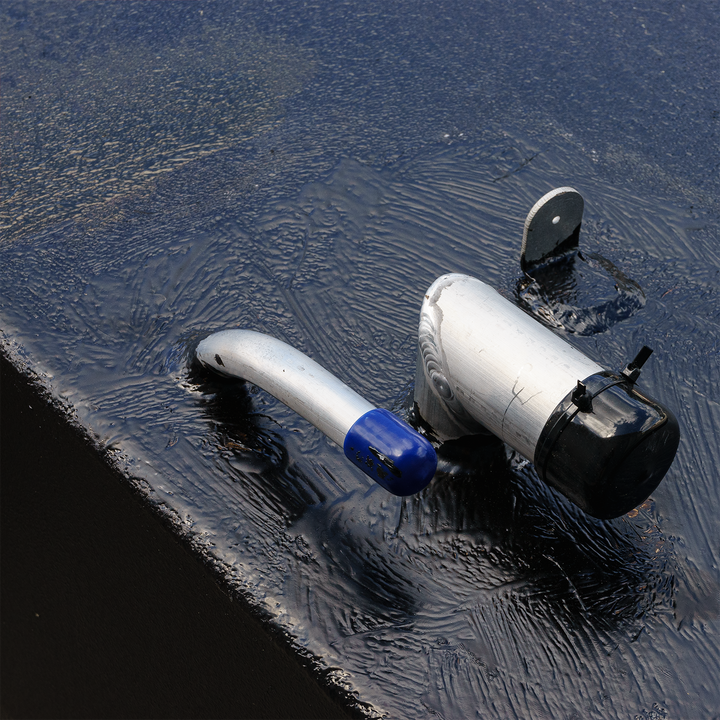 Close-up view of a fuel tank combo kit featuring a large belly tank with a capacity of 128 gallons, two standard saddle tanks with a capacity of 85 gallons each, and a water tank with a capacity of 21.26 gallons. The image shows a fuel fill neck and vent on the surface of the tank