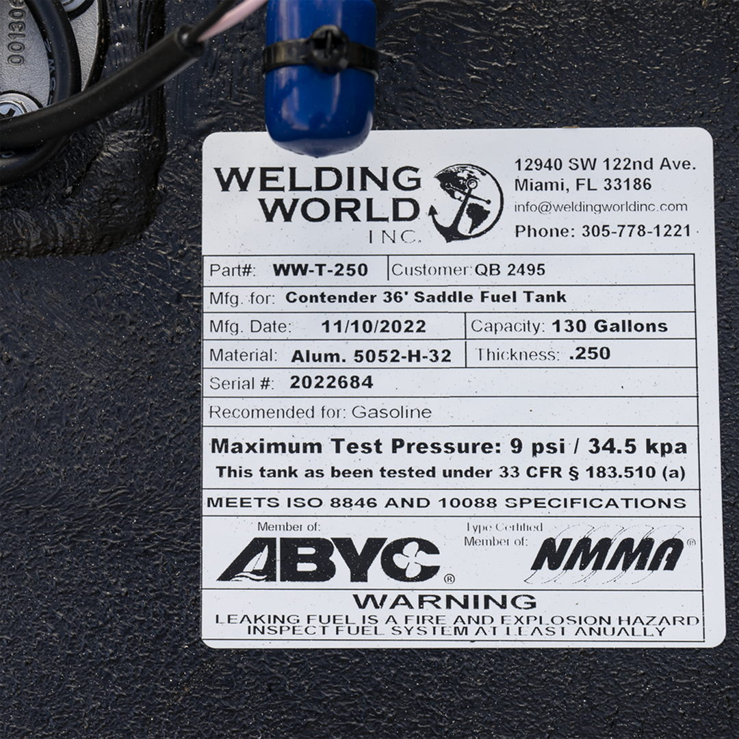 Close-up of a Welding World Inc. label on a black aluminum fuel tank. The label lists part number WW-T-250 for a Contender 36' saddle fuel tank, manufactured on 11/10/2022. Capacity is 130 gallons, made of Aluminum 5052-H-32 with 0.250-inch thickness. Serial number 2022684. Recommended for gasoline. Certified by ABYC and NMMA, meeting ISO 8846 and 10088 specifications. Warning about fire and explosion hazard from leaking fuel. Contact info includes Miami, FL address and phone number 305-778-1221