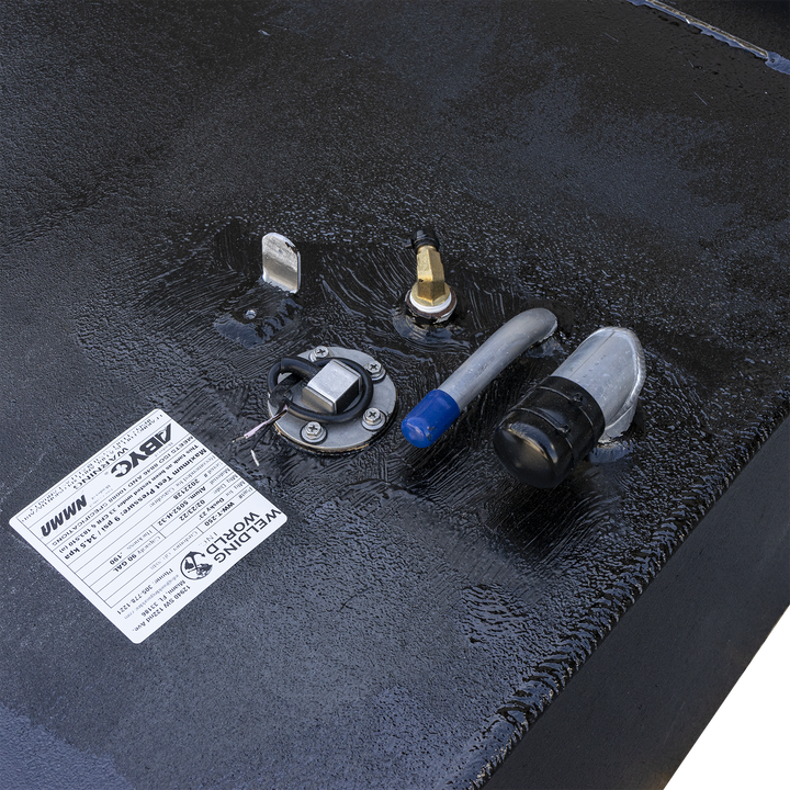 Component layout for pressure-rated fluid enclosure, model UWWM, fabricated by Welding World. Topside fittings include metallic sensor with electrical lead, dual hose ports with distinct connectors, and a threaded valve fitting. Affixed ABYC-compliant label confirms operational range: 150 PSI maximum pressure, temperature limits from -20°F to 200°F, and manufacture date of 01/01/2023. Configuration supports monitored pressurization and regulated flow for marine or industrial systems