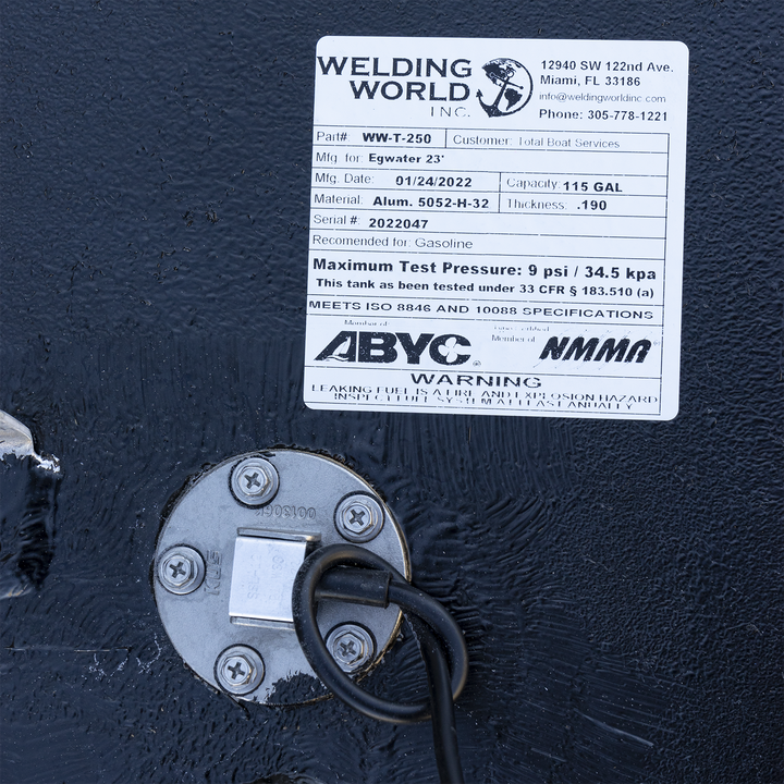 Certification label for the 117-gallon aluminum belly fuel tank installed in the 2005 Edgewater 23 center console. Issued by Welding World Inc. (Part #WW-T-250, Serial #2022047), the label confirms .190″ 5052-H32 marine-grade aluminum construction and specifies compatibility with gasoline. It documents a manufacturing date of 01/24/2022 and lists a 9 psi max test pressure under 33 CFR § 183.510(a). The tank meets ISO 8846 and 10088 standards and includes ABYC and NMMA compliance logos