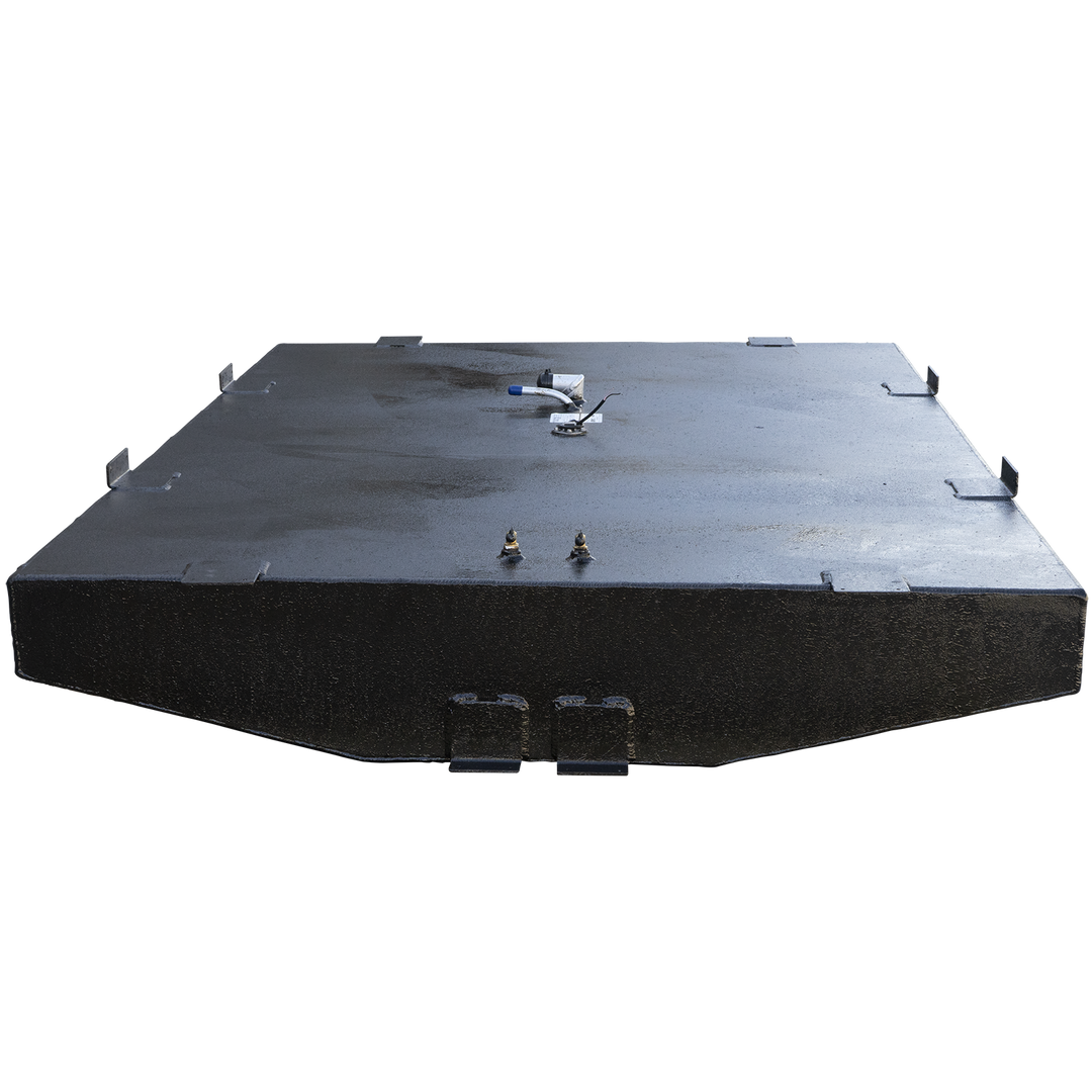 A wide, black, textured fuel tank with an irregular shape, featuring two rectangular cutouts on its underside. The top surface of the tank is equipped with various fittings: multiple small rectangular protrusions, two brass-colored cylindrical components, a small white label, a circular fuel level sender with wires, and a bent pipe with a blue cap