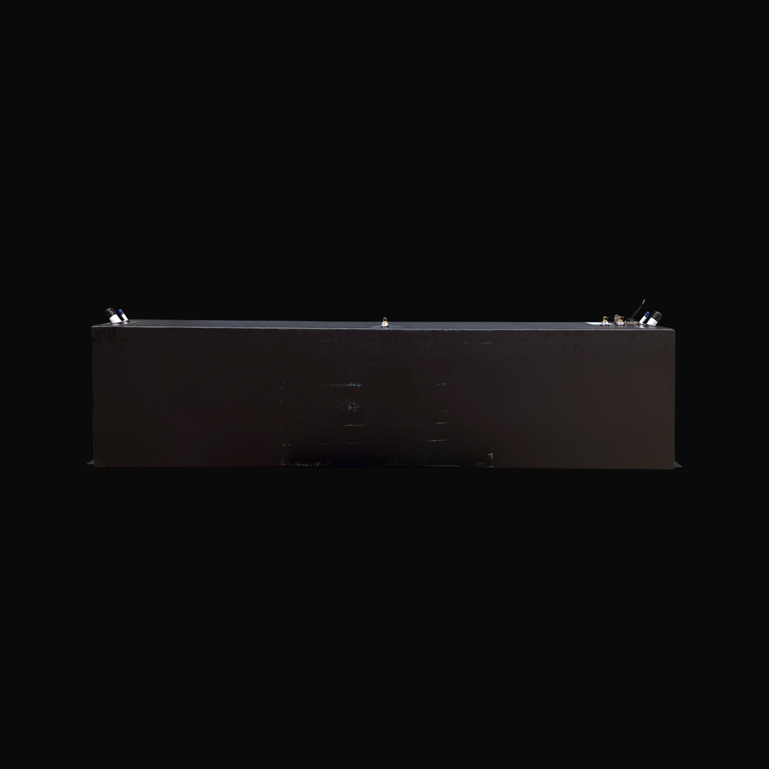 A full side elevation view of the opposite side of the Fiesta Vee Rinker 340 replacement marine fuel tank, showcasing its clean, continuous rectangular profile and protective black TarGard epoxy finish. This perspective highlights the low-profile mounting flanges extending along the bottom edges for secure hull installation. The top deck exhibits the clean alignment of marine-grade hardware, including fuel fill and vent ports on the left, a center brass fitting, and the fuel sending unit assembly on the rig