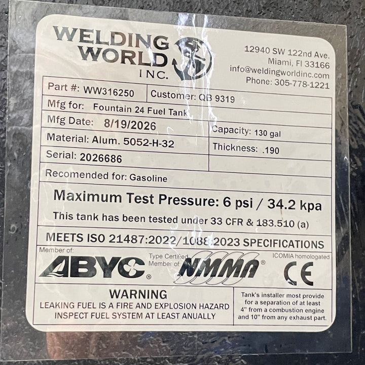A close-up studio detail view of the official manufacturer specification and compliance certification tag applied to the textured black TarGard epoxy finish of a finished Fountain 24 OEM replacement marine fuel tank (130 gal) from file image_c46ae3.jpg. Certified by Welding World Inc. in Miami, FL, the spec plate confirms part number WW316250, serial number 2026686, heavy-duty .190-thickness marine-grade Alum. 5052-H-32 construction, gasoline compatibility, 6 psi / 34.2 kPa maximum pressure testing under 33