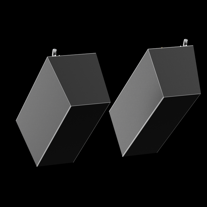 Two dark grey, rectangular fuel tanks are angled against a black background, appearing to lean inward towards each other. Each tank has a thin white outline along its edges and a small white cylindrical fitting protruding from its top surface