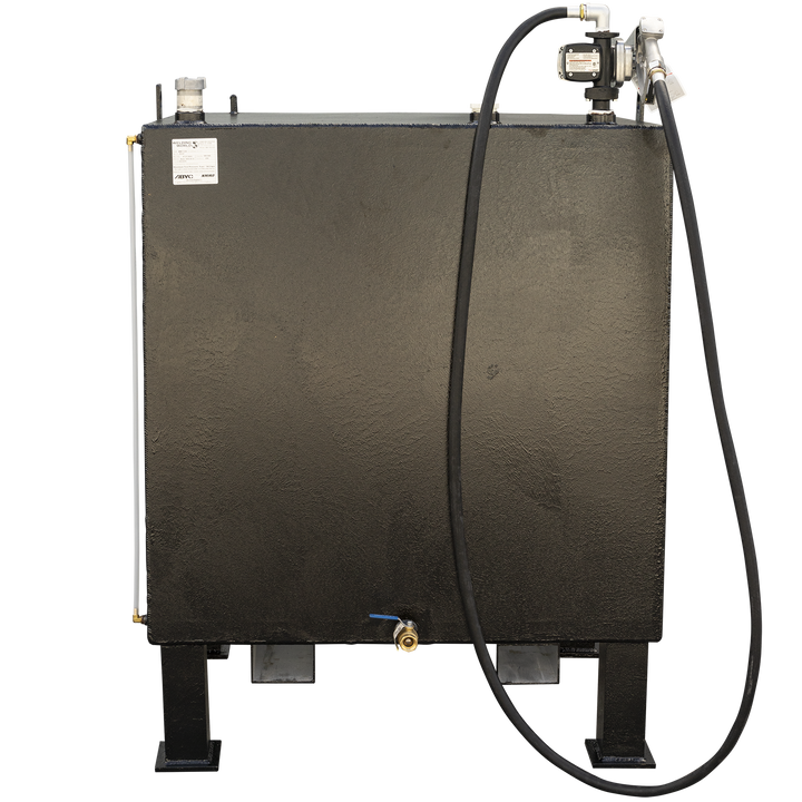 A front view of a black, rectangular fuel tank on black legs, with a fuel pump and nozzle assembly on the top right. A black hose extends from the nozzle, draped over the front of the tank. A white tube with a brass fitting runs vertically along the left side, and a small brass valve with a blue handle is visible near the bottom center. A white label is affixed to the top left of the tank
