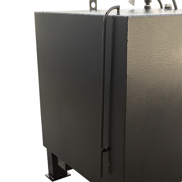 A close-up view of the back left corner of a black, textured fuel tank, showing a dark rod or pipe running vertically along the edge, with a small black attachment near the bottom. The top of the tank has a lifting hook, and the tank rests on a black, square leg